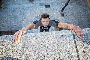 Freerunner climbing up wall