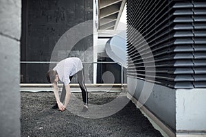 Freerunner Stretching on a Rooftop