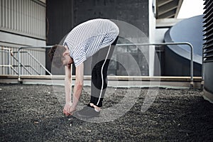 Freerunner Stretching on a Rooftop