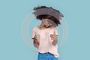 Freestyle. African girl standing  on gray shaking head thumbs up smiling cheerful