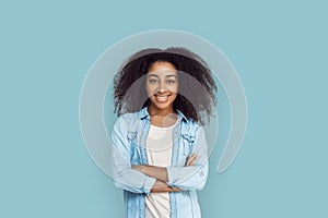 Freestyle. African girl standing isolated on gray crossed arms smiling positive