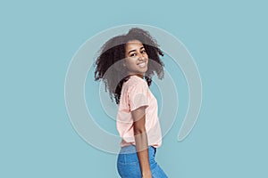 Freestyle. African girl standing isolated on gray posing smiling cheerful
