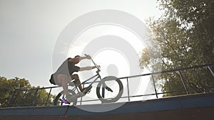 Freestyle. BMX rider slides on bike on ramp in skate park. Street culture