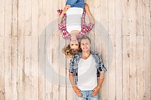 Freestyle. Young man and woman upside down lying on floor smilign happy top view