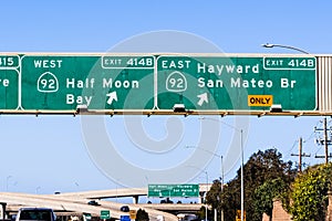 Freeway interchange in San Francisco Bay Area; Freeway signage providing information about the lanes going to 92 West towards Half