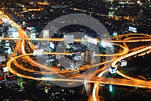 Freeway in night with cars light in modern city