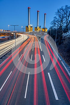 Freeway and power station at dusk