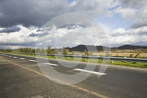 Freeway under cloudy sky