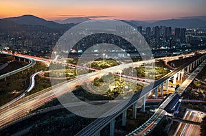 Freeways in an empty city at dusk with the sun setting