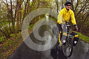 Freewheeling through the forest. a male cyclist enjoying a bike ride on a wet winters morning.