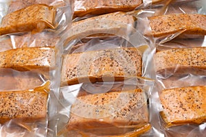 Freeze cooked salmon in vacuum packs on grunge table, concept of food preservation