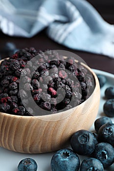 Freeze dried and fresh blueberries on table, closeup