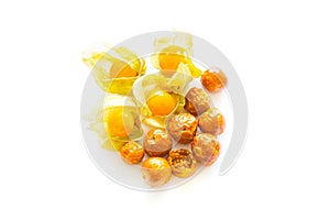 Freeze dried and fresh physalis on a white background.