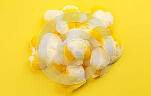 Freeze Dried Lemon Flavored Candy on a Bright Yellow Background