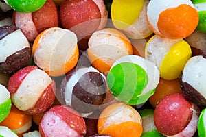 Freeze dried Skittles hard candy macro with splits through their centers. photo