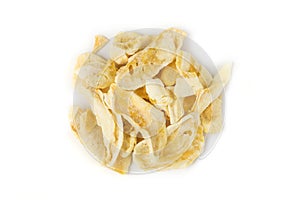 Freeze dried mango slices in a heap isolated over white. Top down view