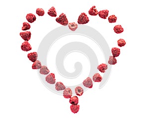 Freeze dried raspberries on a white background in the form of heart. Lyophilization. Food for astronauts.