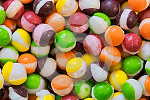 Freeze dried Skittles hard candy colorful macro with splits through their centers.