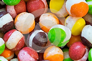 Freeze dried Skittles hard candy macro with splits through their centers.