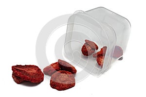 Freeze dried strawberries on a white background on plastic bowl