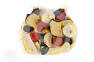 Freeze dried strawberry, blackberry, raspberry, apple, mango and banana pieces isolated over white. Top down view