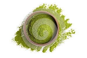 Freeze dried young organic wheatgrass powder in wooden bowl isolated on white