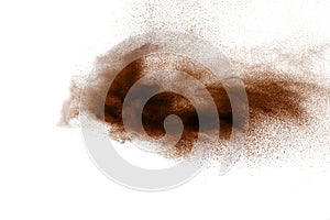 Freeze motion of brown dust explosion. Stopping the movement of brown powder. Explosive brown powder on white background