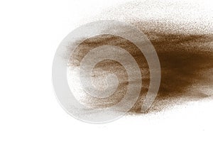 Freeze motion of brown dust explosion. Stopping the movement of brown powder. Explosive brown powder on white background