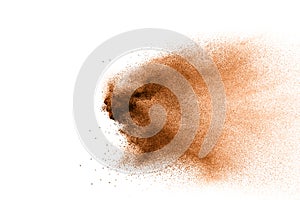 Freeze motion of brown dust explosion. Stopping the movement of brown powder. Explosive brown powder on white background