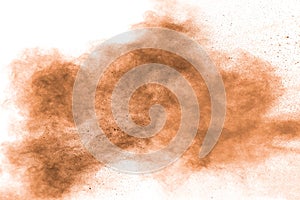 Freeze motion of brown powder exploding. Abstract design of brown dust cloud against white background