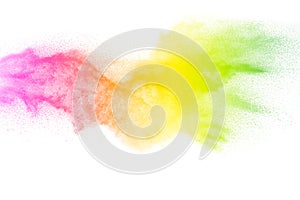 Freeze motion of color particles on white background. Multicolored granule of powder explosion