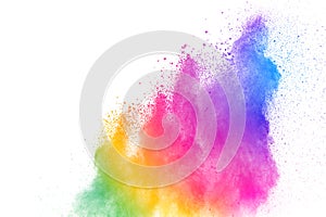 Freeze motion of colored powder explosions isolated on white background.Color dust particle splattered on background