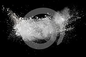 Freeze motion explosion of white powder on a black background.Stopping the movement of white dust on dark background