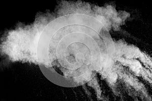 Freeze motion explosion of white powder on a black background.Stopping the movement of white dust on dark background