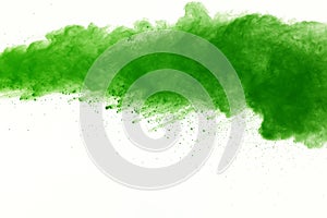 Freeze motion of Green powder exploding on white background.
