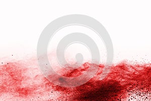 Freeze motion of red powder exploding, isolated on white background.