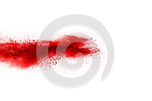 Freeze motion of red powder exploding, isolated on white background.