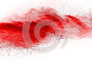 Freeze motion of red powder exploding, isolated on white background.