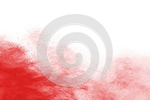 Freeze motion of red powder exploding, isolated on white background.