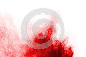 Freeze motion of red powder exploding, isolated on white background.