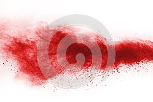 Freeze motion of red powder exploding, isolated on white background.