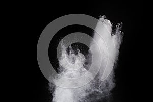 Freeze motion of white color powder exploding on black background.