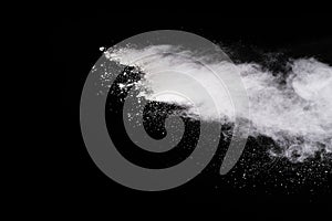 Freeze motion of white color powder exploding on black background.