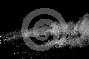 Freeze motion of white color powder exploding on black background