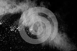 Freeze motion of white color powder exploding on black background