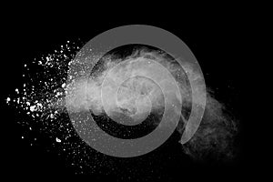 Freeze motion of white color powder exploding on black background