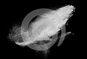 Freeze motion of white dust explosions isolated on black background