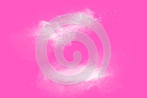 Freeze motion of white particles on pink background. Abstract white dust explosion