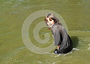 Freezing boy standing in water