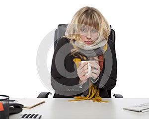 Freezing businesswoman warming up with coffee photo